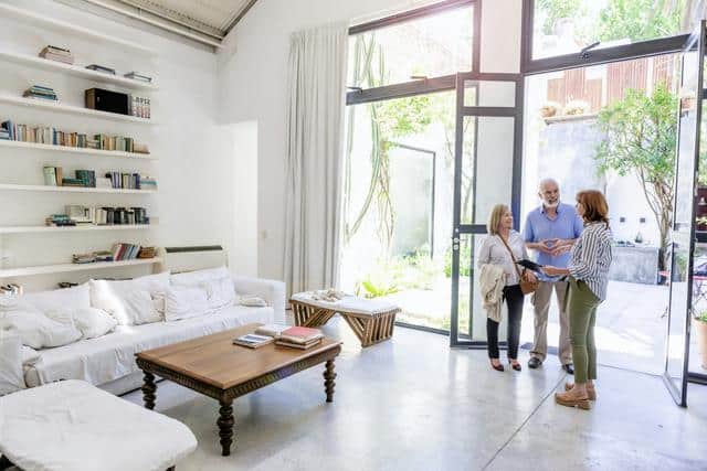 real estate agent in California shows home to couple