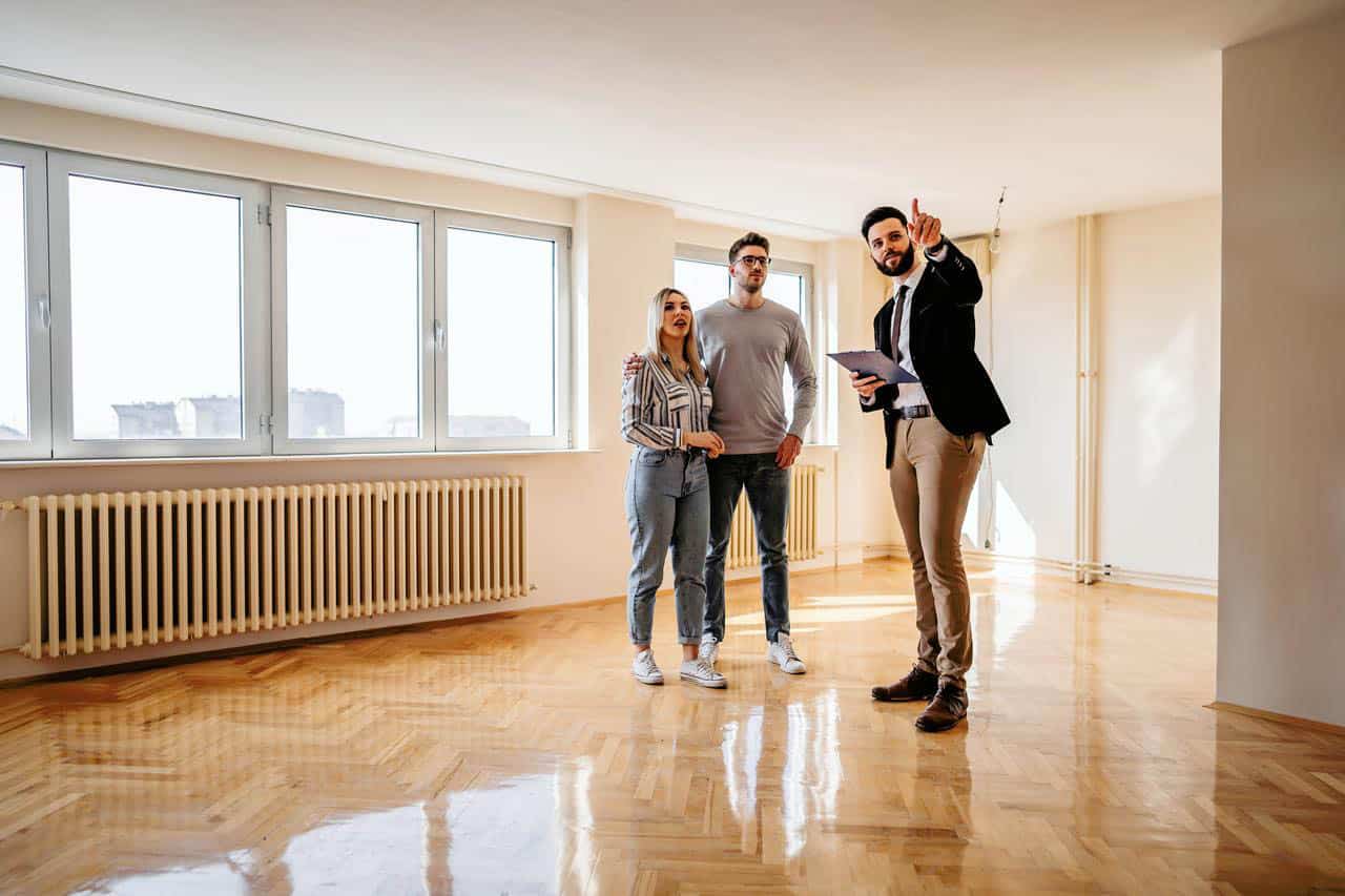 real estate agent shows rental property to couple - rental market as a real estate agent