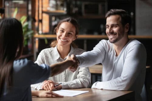 Happy couple celebrates a real estate deal. Master real estate negotiation