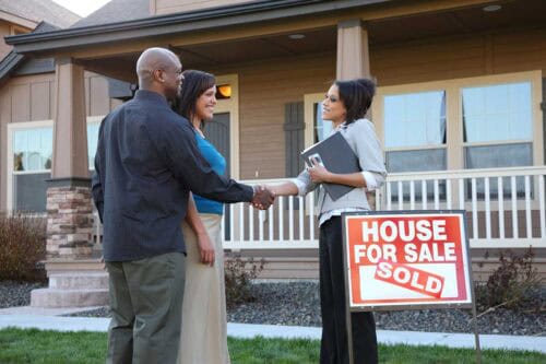 real estate agent congratulates buyers